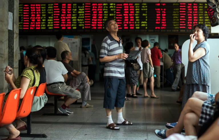 Investors monitor screens showing stock market movement at a brokerage house in Shanghai in August 2015