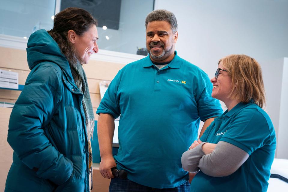 Supporter and partner Lily Hamburger, 37, with Invest Detroit and the New Economy Initiative, left, talks with Lutalo Sanifu, director of neighborhood resilience, safety and business district services at Jefferson East Inc., and Christie Ayotte Baer, assistant executive director of the center on finance, law and policy at University of Michigan, during a small business resource fair hosted by Jefferson East, Inc. at the Neighborhood Resource Hub in Detroit on March 20, 2023.