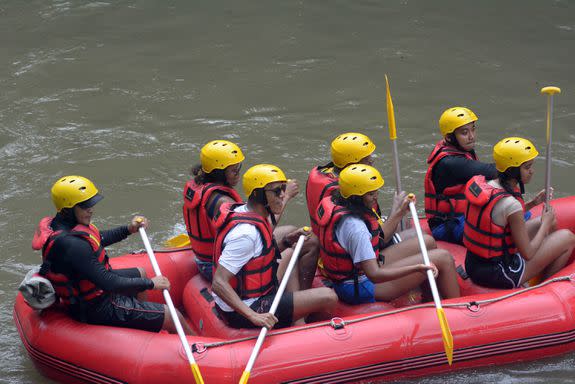 Former US president Barack Obama (3rd L), his wife Michelle (2nd L) and his daughters Sasha (front C) and Malia (R) go rafting at Bongkasa Village in Badung on Bali island on June 26, 2017. Barack Obama kicked off a 10-day family holiday in Indonesia that will take in Bali and Jakarta, the city where he spent part of his childhood, officials said on June 24. / AFP PHOTO / STR (Photo credit should read STR/AFP/Getty Images)