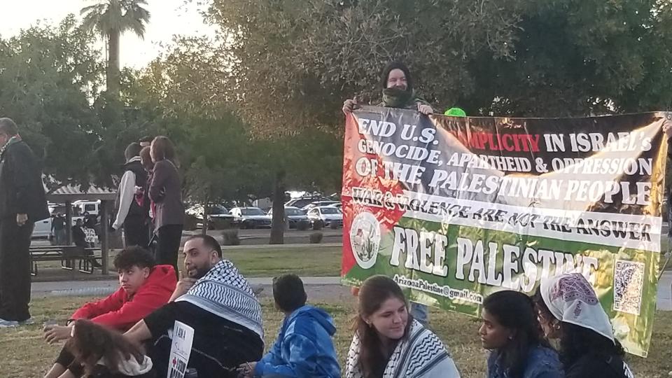 A pro-Palestinian banner is seen unfurled at gathering Sunday, Dec. 3, 2023 at Eastlake Park in Phoenix.