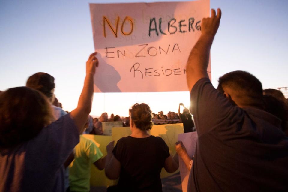 The Mexican government plans to convert a shuttered grocery store in Mexicali into a shelter for migrants awaiting immigration hearings in the United States. Here, protesters gather Monday, Oct. 14, 2019.