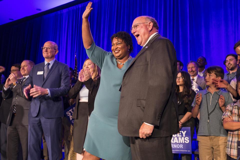 Georgia Democratic Party Chair DuBose Porter, right, stands with Georgia Democratic gubernatorial candidate Stacey Abrams during the Georgia Democratic Convention in Atlanta, Saturday, Aug. 25, 2018. (Alyssa Pointer/Atlanta Journal-Constitution via AP)