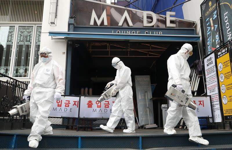 Quarantine worker spray disinfectants in front of a night club on the night spots in the Itaewon neighborhood, following the coronavirus disease (COVID-19) outbreak, in Seoul