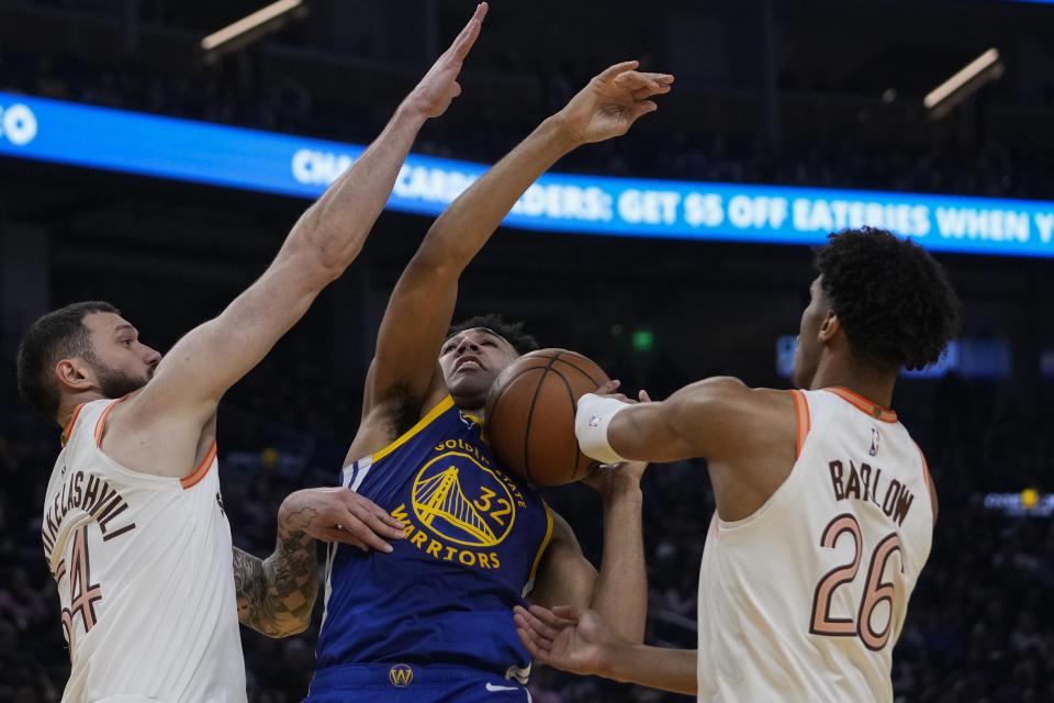 Golden State Warriors center Trayce Jackson-Davis (32) is fouled by San Antonio Spurs forward Dominick Barlow, right, during the first half of an NBA basketball game Saturday, March 9, 2024, in San Francisco. (AP Photo/Godofredo A. Vásquez)