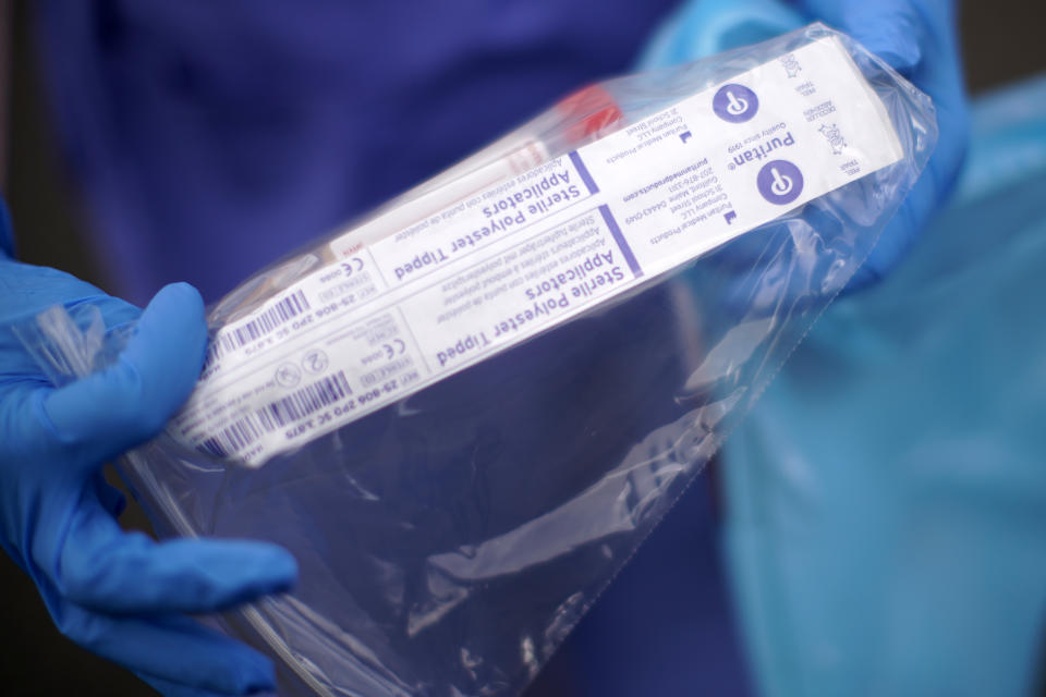 WOLVERHAMPTON, ENGLAND - MARCH 12: A NHS nurse holds a Coronavirus testing kit as she speaks to the media at a drive through Coronavirus testing site in a car park on March 12, 2020 in Wolverhampton, England. The National Health Service facility has been set up in a car park to allow people with NHS referrals to be swabbed for Covid-19. (Photo by Christopher Furlong/Getty Images)