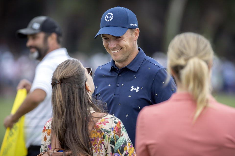 Jordan Spieth, center, greets his wife, Annie Spieth, on the 18th green after winning a one-hole playoff during the final round of the RBC Heritage golf tournament, Sunday, April 17, 2022, in Hilton Head Island, S.C. (AP Photo/Stephen B. Morton)