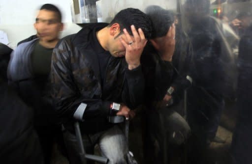 A Palestinian man mourns in a hospital after two militants of the Al Quds Brigades, the military arm of Islamic Jihad, were killed in an Israeli air strike in Gaza City. Palestinian medical officials said Saturday morning that a total of 11 people had been killed and 15 more injured in Israeli air strikes in the Gaza Strip