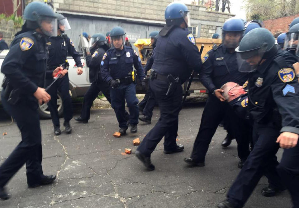 An injured police officer is carried away by his fellow officers on Westbury Avenue in Baltimore during riots on Monday, April 27, 2015. Photo by Erica Green/Baltimore Sun/TNS/ABACAPRESS.COM