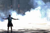 A demonstrator is seen among tear gas during a protest against Brazilian President Jair Bolsonaro, in Sao Paulo