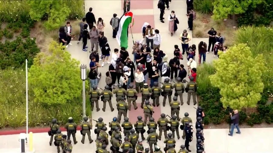 Law enforcement officers are seen approaching a protest encampment at UC Irvine on May 15, 2024. (KTLA)