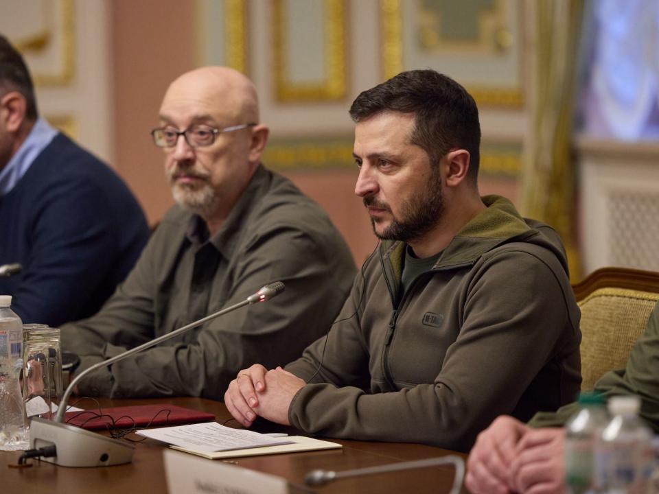 President Volodymyr Zelenskyy seated at a conference table with two Ukrainian officials in Kyiv, November 3, 2022.