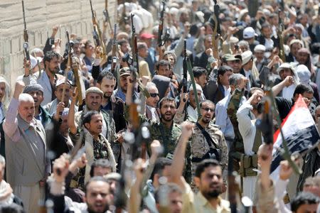 Armed people demonstrate outside the United Nations offices against Saudi-led air strikes on funeral hall in Sanaa, the capital of Yemen, October 9, 2016. REUTERS/Khaled Abdullah