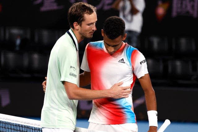 Daniil Medvedev, left, and Felix Auger-Aliassime share words at the net