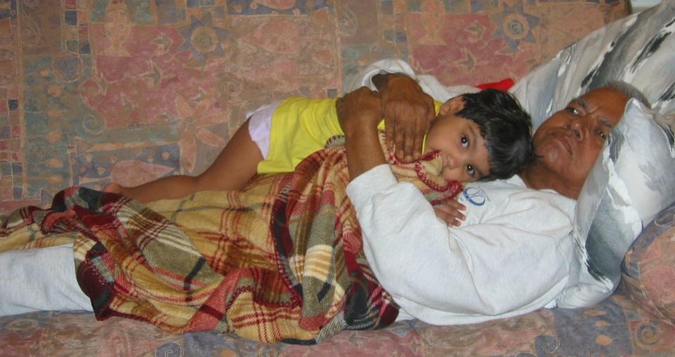 A young Meena Kumar snuggles with her grandfather. (Courtesy of Jayashree Subrahmonia)