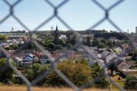 The village of Spangdahlem and radar towers of the U.S. Spangdahlem Air Base are seen through a fence in the Eifel region near Bitburg