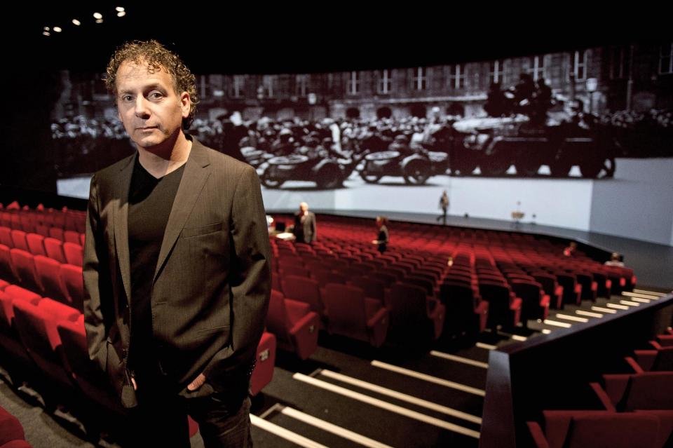 In this photo taken Friday, May 2, 2014 producer Robin de Levita poses during an interview with the Associated Press at Theater Amsterdam. Seeking to engage a new generation with the tragic story of Anne Frank, a major new play based on the Jewish teenager's diary opens Thursday, May 8, 2014 in Amsterdam. It's the first time a theatrical production has been forged directly from Frank's actual writings since the award-winning 1950s play that escalated her story, then little-known, to the world's attention. It's being staged in a purpose-built 1,100 seat theater that includes a replica of the secret apartment where Frank and her family hid from the Nazis in World War II. (AP Photo/Evert Elzinga)