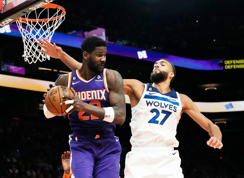 Phoenix Suns center Deandre Ayton (22) rebounds the ball against Minnesota Timberwolves center Rudy Gobert (27) in the second half at Footprint Center in Phoenix on March 29, 2023.