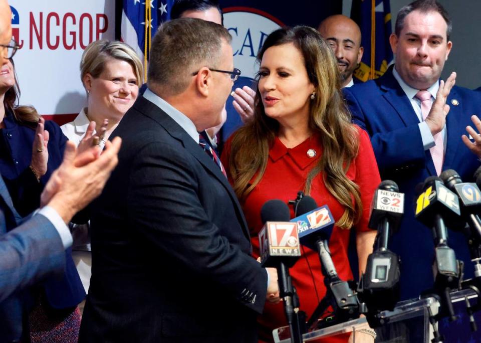 N.C. House Speaker Tim Moore, left, congratulates N.C. State Rep. Tricia Cotham as she heads up to the podium to speak during a press conference at the N.C. GOP headquarters in Raleigh, N.C., Wednesday, April 5, 2023. The press conference was to announce Rep. Cotham is switching parties to become a member of the House Republican caucus.