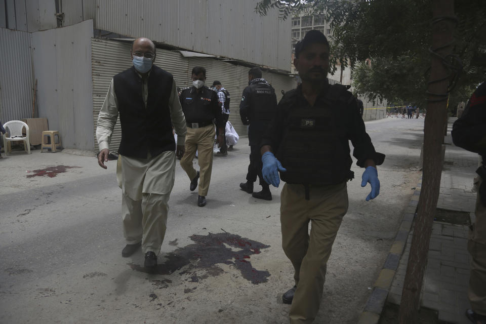 Police officers head to the Stock Exchange Building in Karachi, Pakistan, Monday, June 29, 2020. Gunmen have attacked the stock exchange in the Pakistani city of Karachi on Monday. Special police forces deployed to the scene of the attack and in a swift operation secured the building. (AP Photo/Fareed Khan)