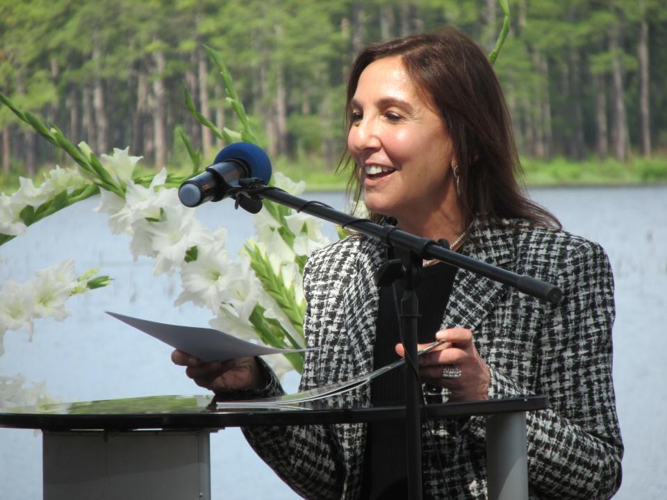 Rachel Jacobson, assistant secretary of the Army for installations, energy and environment, makes remarks during the reveal of the completion of a floating solar panel project Friday, June 10, 2022, at Big Muddy Lake on Camp Mackall.