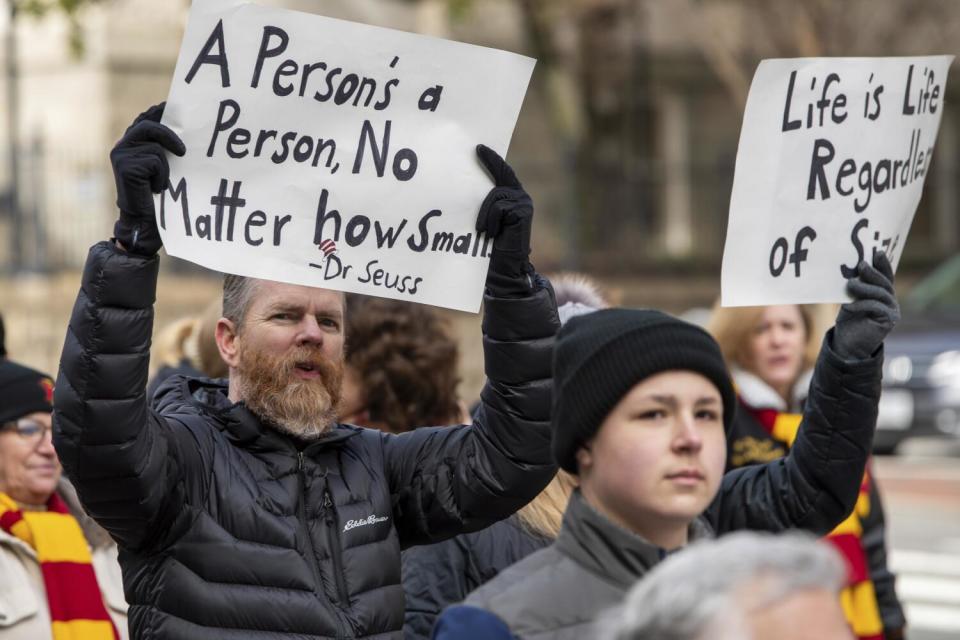 People hold antiabortion signs during a "March for Life" event.