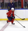 Florida Panthers head coach Joel Quenneville, top, looks on as center Sam Bennett (9) skates during an NHL hockey training camp Thursday, Sept. 23, 2021, in Sunrise, Fla. (David Santiago/Miami Herald via AP)