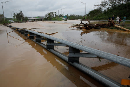 People look at a flooded expressway after the area was hit by Hurricane Maria in Yauco, Puerto Rico September 21, 2017. REUTERS/Carlos Garcia Rawlins