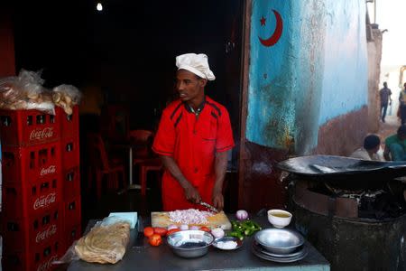Mohamed Aman, 27, prepares fetira for breakfast in front of his coffee shop within the walled city of Harar, Ethiopia, February 24, 2017. REUTERS/Tiksa Negeri