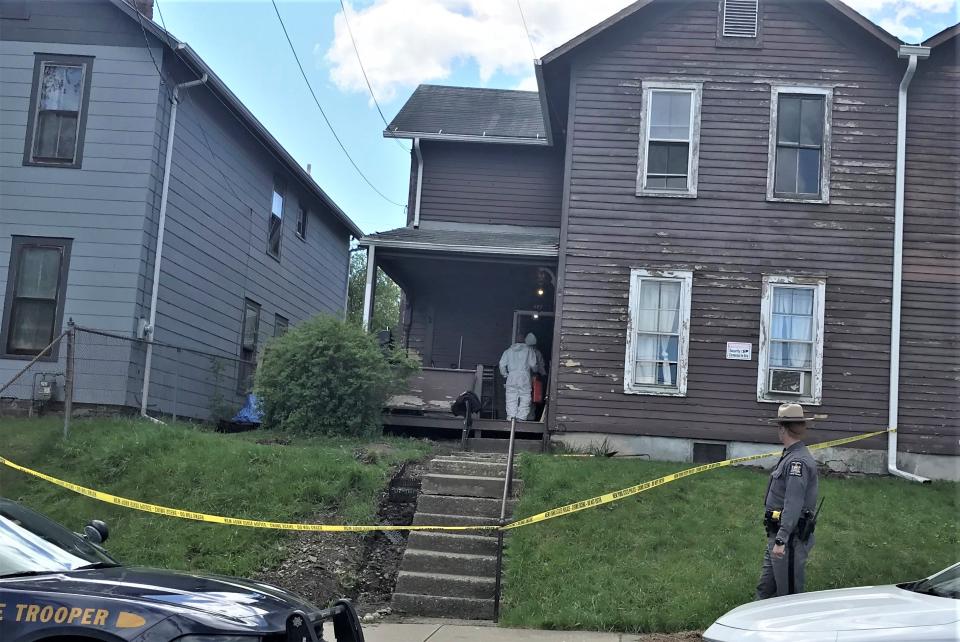 Men in Hazmat suits enter an apartment at 427 Partridge St. in Elmira on Thursday, May 6, 2021 during an investigation that eventually led to the indictment of three men on murder and other felony charges.