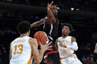 Tennessee guard Kennedy Chandler, right, passes around Texas Tech forward Bryson Williams (11) to Olivier Nkamhoua (13) during the first half of an NCAA college basketball game in the Jimmy V Classic on Tuesday, Dec. 7, 2021, in New York. (AP Photo/Adam Hunger)