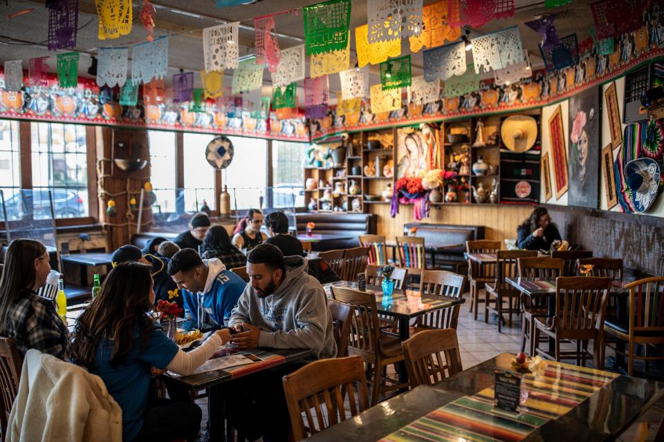 Patrons sit down for dinner in the taqueria at La Jalisciense Supermercado & Taqueria in southwest Detroit on Monday, Oct. 30, 2023.