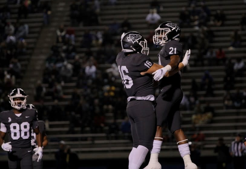 NORWALK, CA - DECEMBER 14, 2019: St John Bosco running back Rayshon Luke (21) celebrates his touchdown with St John Bosco tight end Adam Awaida (16) against De La in the first half of the CIF state championship Open Division at Cerritos College on December 14, 2019 in Norwalk, California. (Gina Ferazzi/Los AngelesTimes)