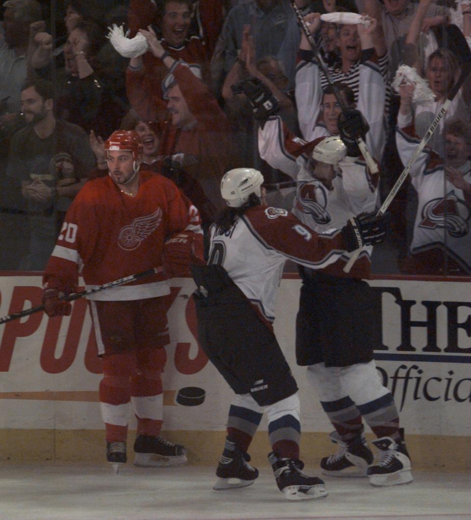 Detroit Red Wings' Martin Lapointe looks away as Colorado Avalanche's Mike Ricci and Claude Lemieux celebrate the go-ahead goal in the third period in Game 1 of the Western Conference finals in Denver, May 15, 1997.