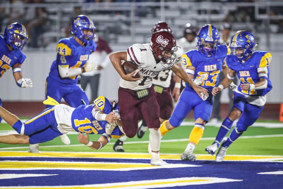 Odem's Nathan Phillips attempts to tackle Mathis' Ethan Ybarra during the game Thursday, Sept. 8, 2022, at Owl Stadium in Odem, Texas.