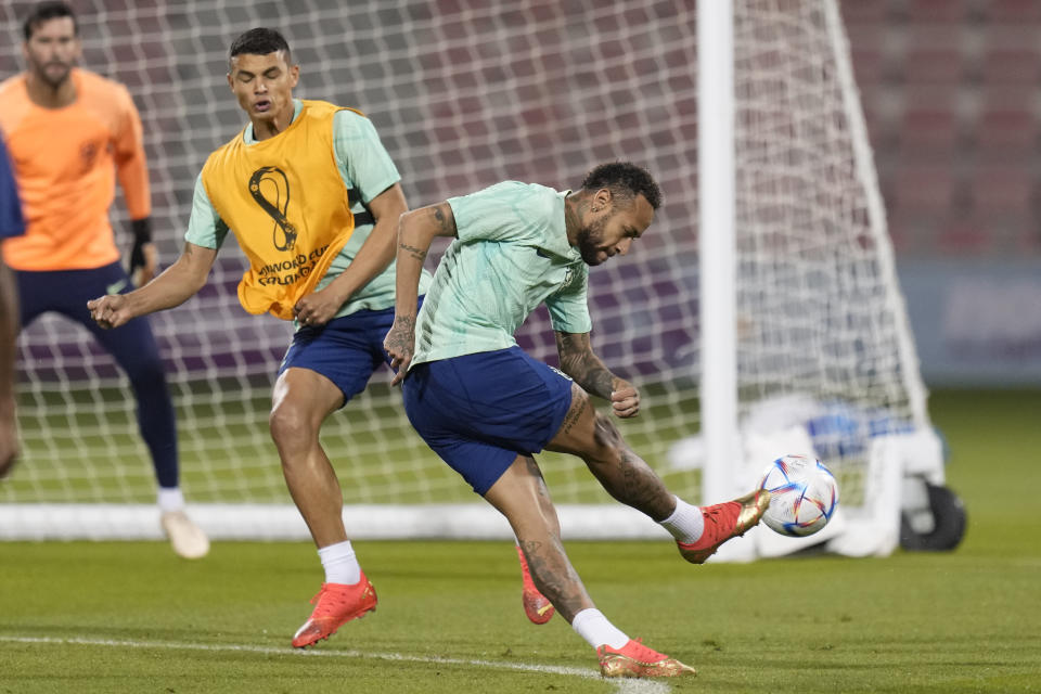 Brazil's Neymar, right, and Thiago Silva practice during a training session at the Grand Hamad stadium in Doha, Qatar, Sunday, Dec. 4, 2022. Brazil will face South Korea in a World Cup round of 16 soccer match on Dec. 5. (AP Photo/Andre Penner)
