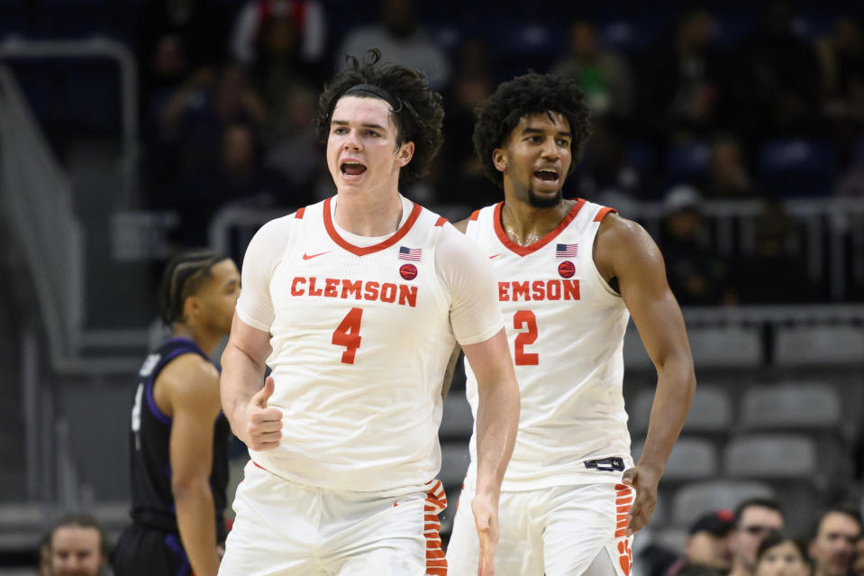 Clemson forward Ian Schieffelin (4) and guard Dillon Hunter (2) celebrate after Schieffelin scored during an NCAA college basketball game against TCU in the Hall of Fame Series in Toronto, Saturday, Dec. 9, 2023. (Christopher Katsarov/The Canadian Press via AP)