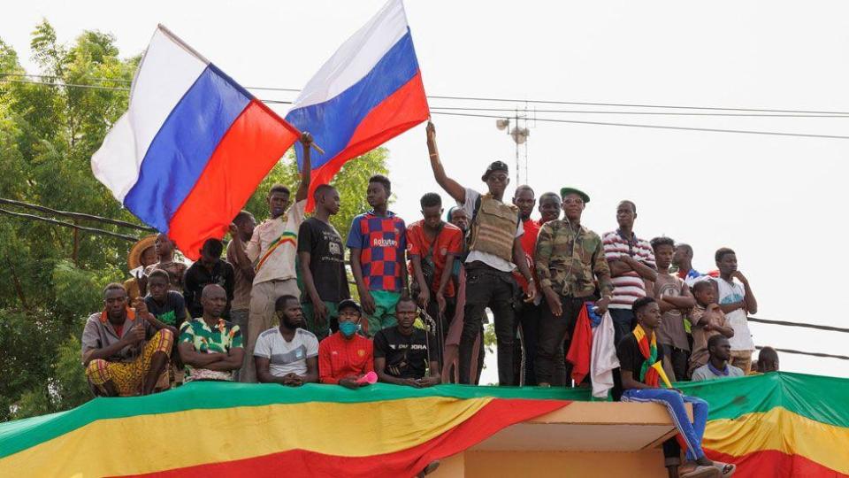 Supporters of the Malian junta wave Russian flags during a pro-Russian demonstration in Bamako, Mali - May 2022