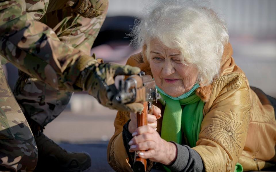 Valentyna Konstantynovska, 79, holds a weapon during a basic combat training for Ukrainian civilians