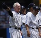 FILE - In this July 7, 2007 file photo, former New York Yankees pitcher, Whitey Ford, left, acknowledges the crowd during introductions as Yogi Berra, right looks on before the Old Timer's game at Yankee Stadium in New York. A family member tells The Associated Press on Friday, Oct. 9, 2020 that Ford died at his Long Island home Thursday night. (AP Photo/Julie Jacobson, File)