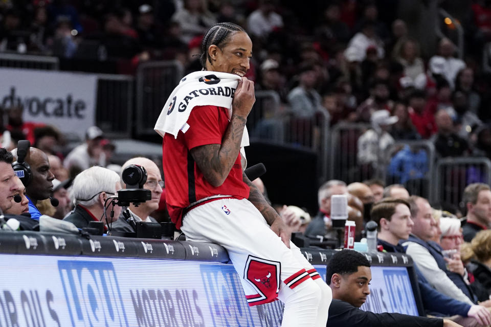 Chicago Bulls forward DeMar DeRozan wipes his face as he watches teammates during the first half of an NBA basketball game against the Memphis Grizzlies in Chicago, Sunday, April 2, 2023. (AP Photo/Nam Y. Huh)