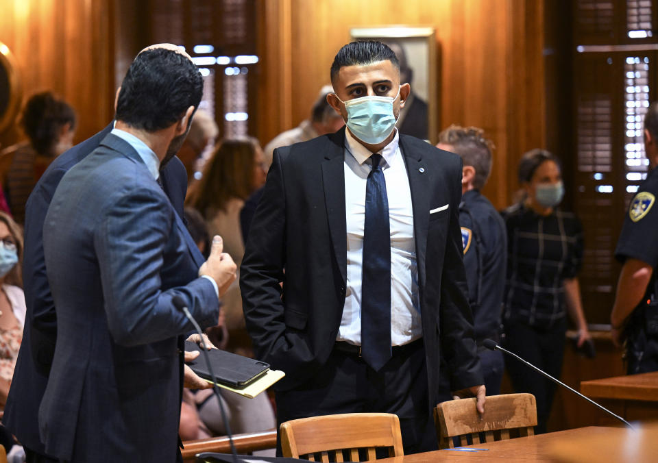 Nauman Hussain, right, waits with his attorneys during a proceeding in Schoharie County court Wednesday, Aug. 31, 2022, in Schoharie, N.Y. A judge rejected a plea agreement that would have meant no prison time for Hussain, the operator of a limousine company involved in a crash that killed 20 people in upstate New York, drawing applause and tears from victims’ relatives who packed the court. (AP Photo/Hans Pennink)