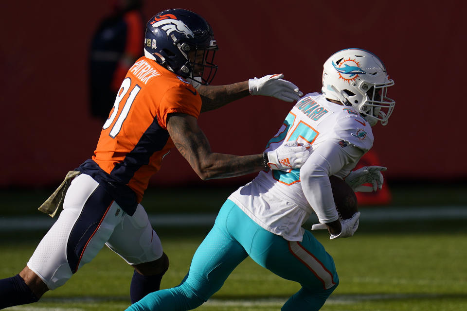 Miami Dolphins cornerback Xavien Howard (25) runs back an interception intended for Denver Broncos wide receiver Tim Patrick (81) during the first half of an NFL football game, Sunday, Nov. 22, 2020, in Denver. (AP Photo/David Zalubowski)