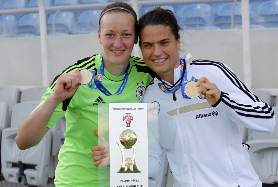 Germany's goalkepeer Almuth Schult, left, and Dzsenifer Marozsan pose for the media with their trophy after winning the women's soccer Algarve Cup at the Algarve stadium, outside Faro, southern Portugal, Wednesday, March 12, 2014. Marozsan, who was the best player of the tournament, scored once in Germany's 3-0 victory. (AP Photo/Francisco Seco)