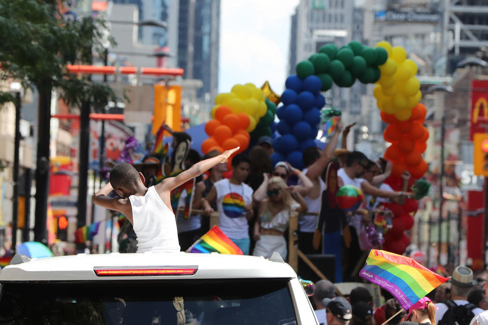 A young boy dabs during the 2016 Toronto Pride parade along Yonge Street in Toronto on July 3, 2016. (Steve Russell/Toronto Star via Getty Images)