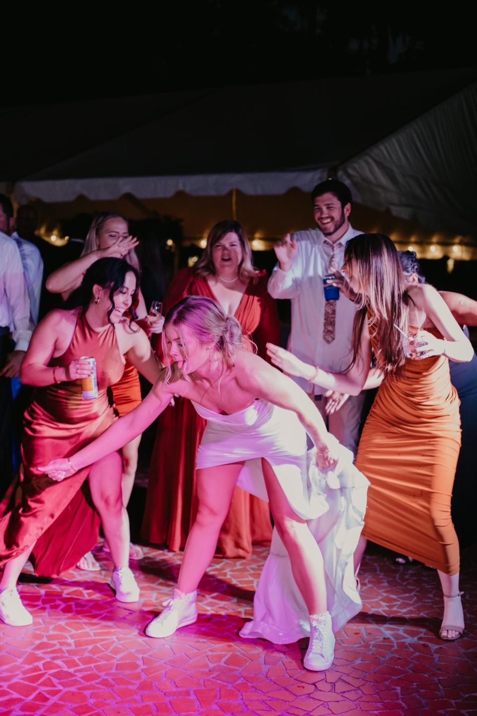 A bride dances with her wedding guests.