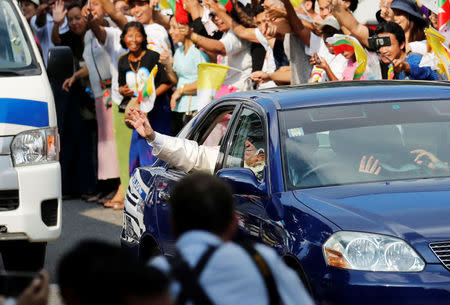 Pope Francis waves as his car travels past well-wishers in Yangon, Myanmar November 27, 2017. REUTERS/Jorge Silva