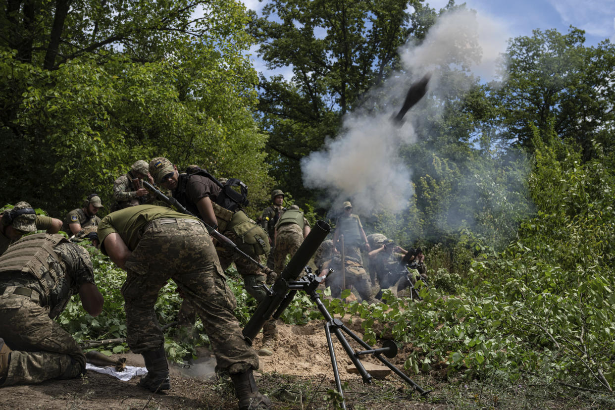 Ukrainian servicemen shoot with 82mm mortar during training in Kharkiv region, Ukraine, Tuesday, July 19, 2022. (AP Photo/Evgeniy Maloletka)