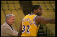 Guard Earvin (Magic) Johnson of the Los Angeles Lakers looks on with Lakers owner Jerry Buss during a game.