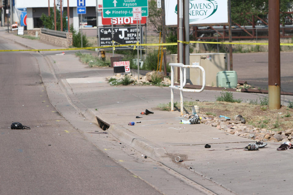 This Saturday, June 19, 2021, photo courtesy of The White Mountain Independent shows the scene of an accident after a pick up truck ran over a group of cyclists in Show Low, Ariz. A driver in a pickup truck plowed into bicyclists competing in a community road race in Arizona on Saturday, critically injuring several riders before police chased down the driver and shot him outside a nearby hardware store, police said. (Jim Headley/The White Mountain Independent via AP)