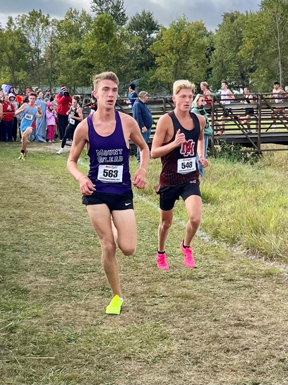 Mount Gilead's Owen Hershner runs against Kade Sutherland of Marion Harding to the finish of a cross country race at Harding earlier this year.